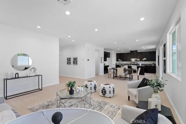 a kitchen with granite countertop a sink and living room view