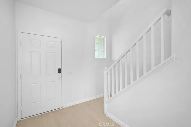 a view of staircase with railing and white walls