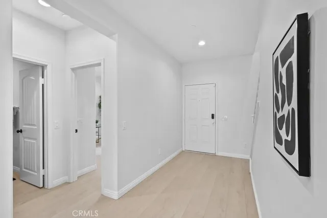 a view of an entryway with wooden floor