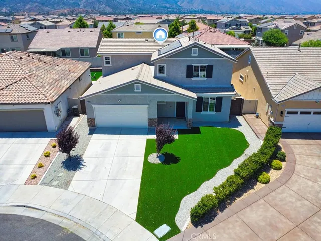 an aerial view of a house with a yard