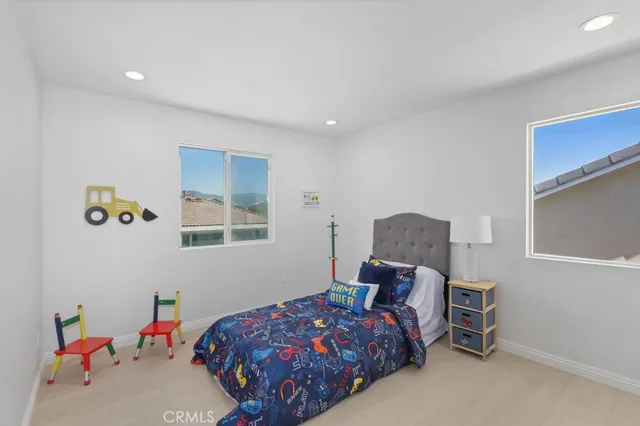 a bedroom with a large bed and a window