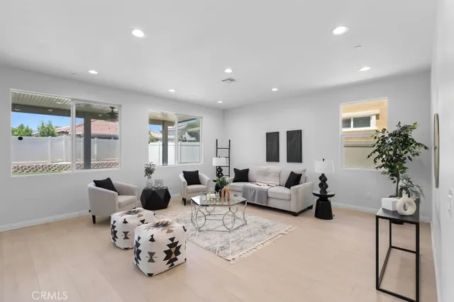 a living room with furniture chess table and a window