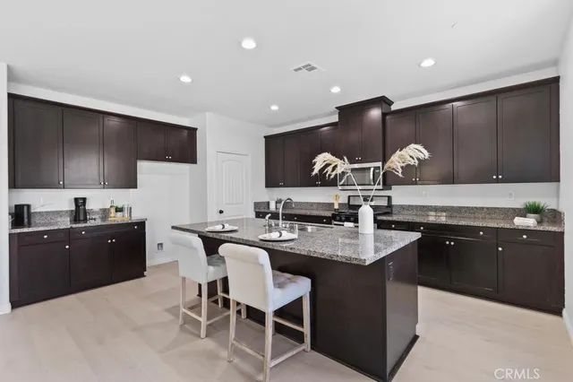 a kitchen with granite countertop a sink and stove