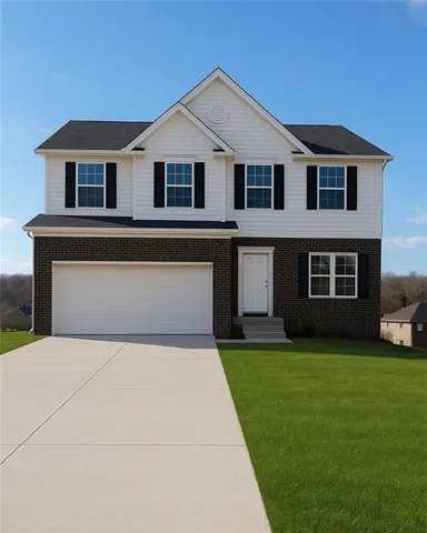 a front view of a house with a garden and yard