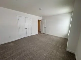 a view of an empty room and closet area