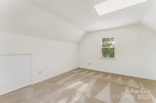 a bathroom with a granite countertop bathtub shower sink vanity and toilet