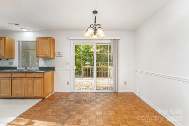 a large kitchen with kitchen island a sink stainless steel appliances and cabinets