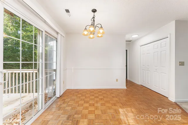 a view of a kitchen with a sink and dishwasher a refrigerator with white cabinets