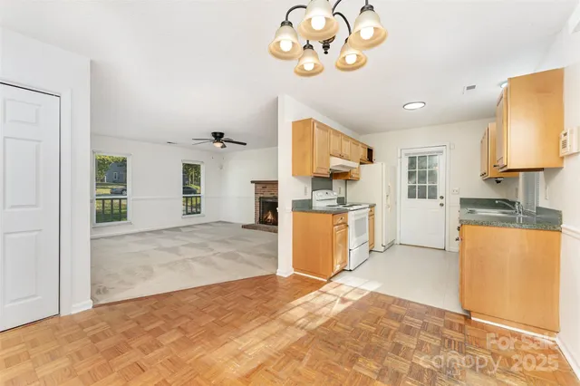a view of an empty room with a fireplace and a window