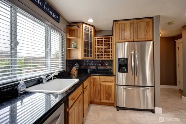 a kitchen with a refrigerator a sink and cabinets