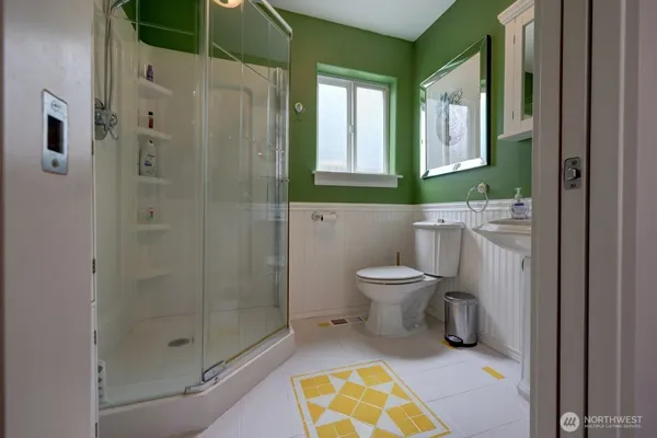 a bathroom with a toilet and a shower