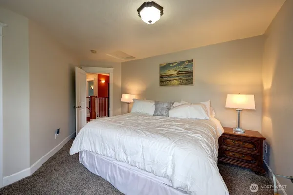a bedroom with a bed and a lamp