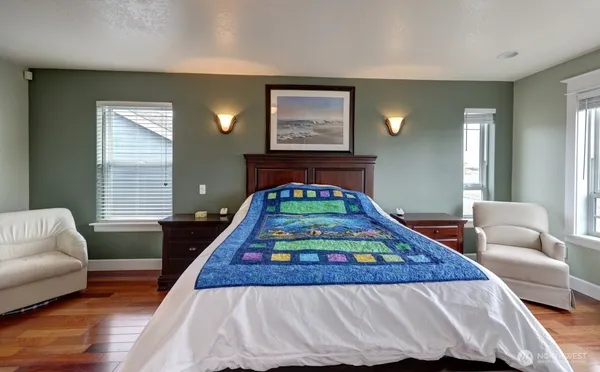 a bedroom with a bed a couch and a window