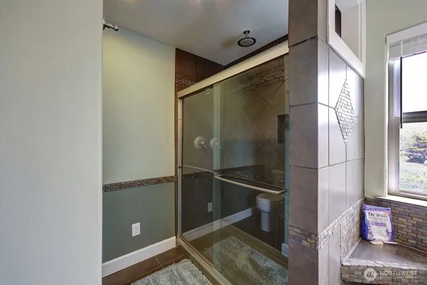a bathroom with a shower and a mirror