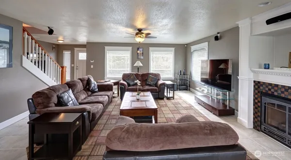 a living room with fireplace furniture and a flat screen tv