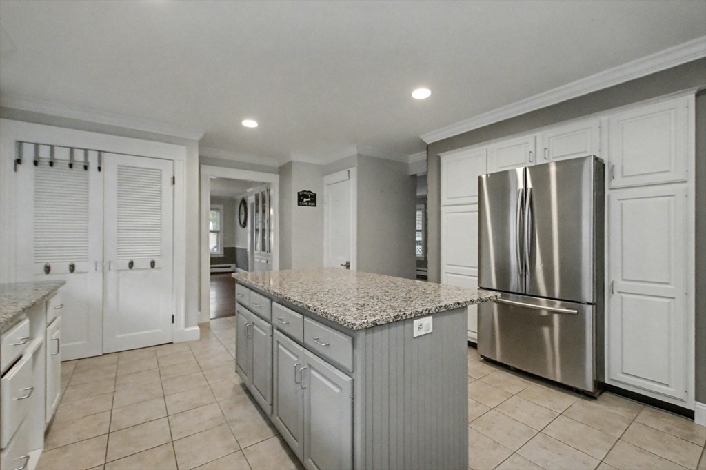 48 Cordis Street Wakefield, MA 01880 - Photo 11 of 35 a kitchen with stainless steel appliances granite countertop a refrigerator and a sink