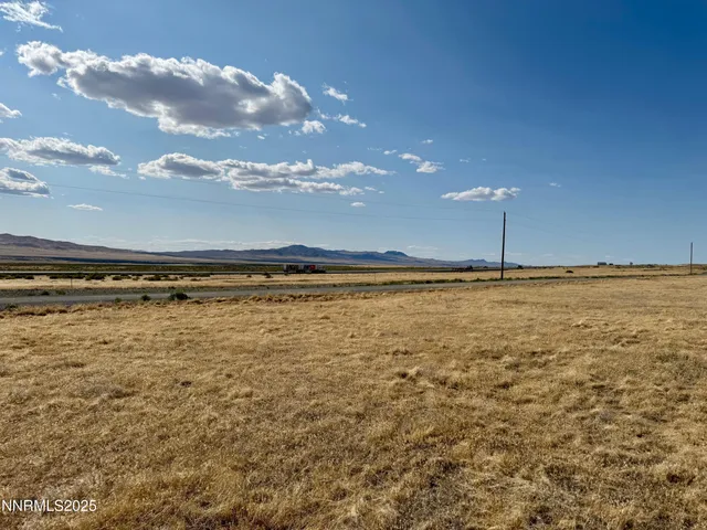 a view of garage with a car parked in it