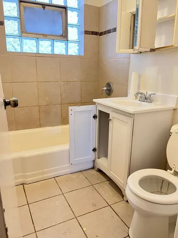 a bathroom with a sink a toilet and bathtub