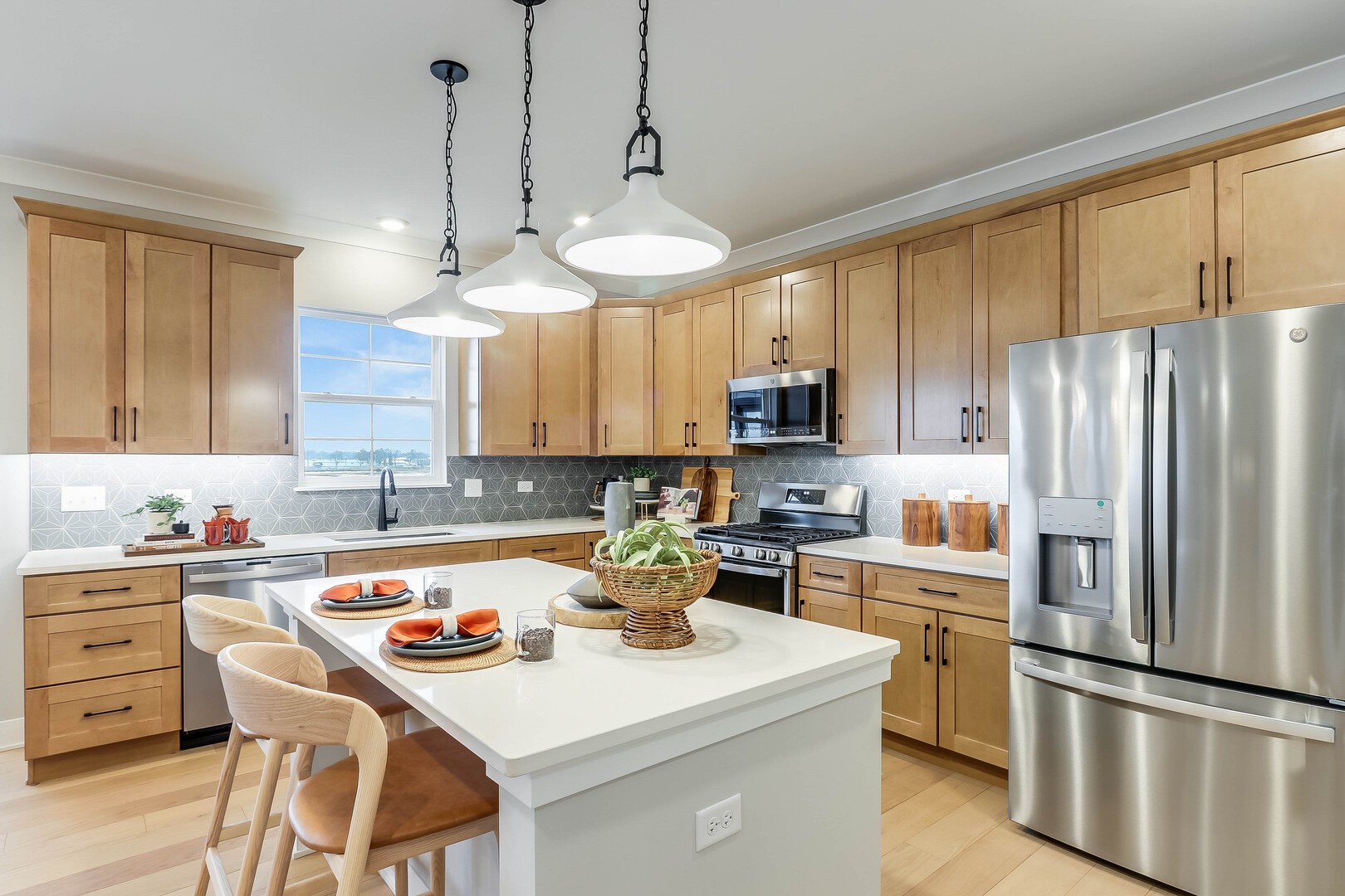 10772 Chadsey Road Huntley, IL 60142 - Photo 14 of 29 a kitchen with a refrigerator a stove a sink and white cabinets