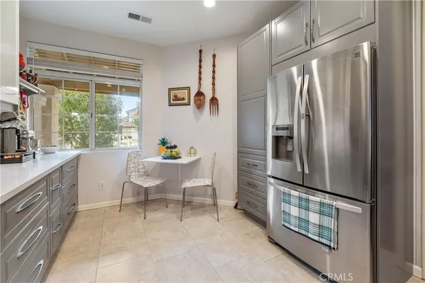 a kitchen with stainless steel appliances granite countertop a refrigerator a sink and a stove