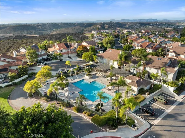 an aerial view of residential houses with outdoor space