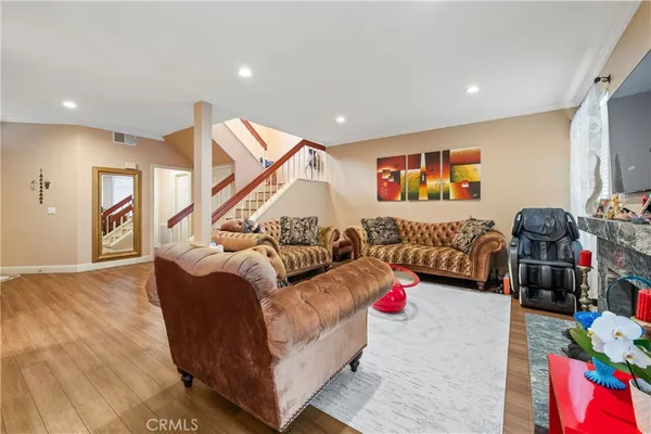 a dining room with furniture a chandelier and wooden floor