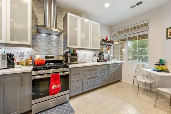a kitchen with stainless steel appliances a refrigerator and a table