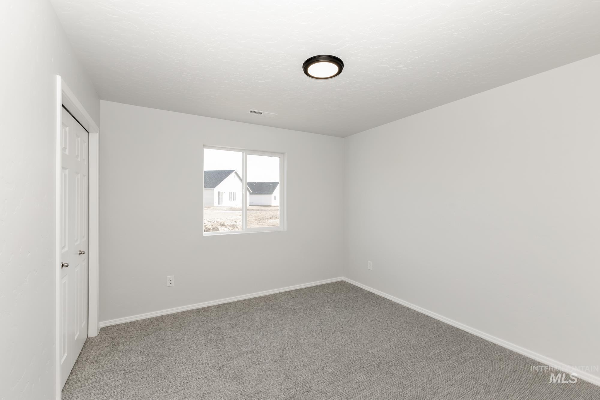 3070 South Maple Rnch Way Nampa, ID 83686 - Photo 17 of 33 Unfurnished bedroom featuring a closet and carpet flooring
