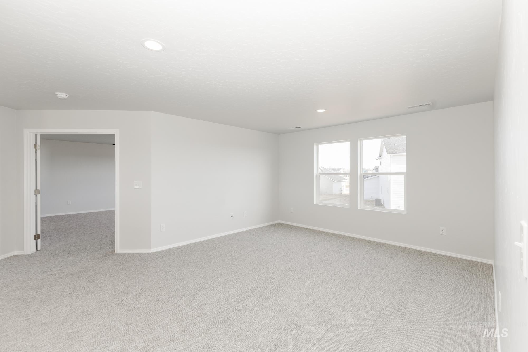 3070 South Maple Rnch Way Nampa, ID 83686 - Photo 21 of 33 Unfurnished room with light carpet and recessed lighting