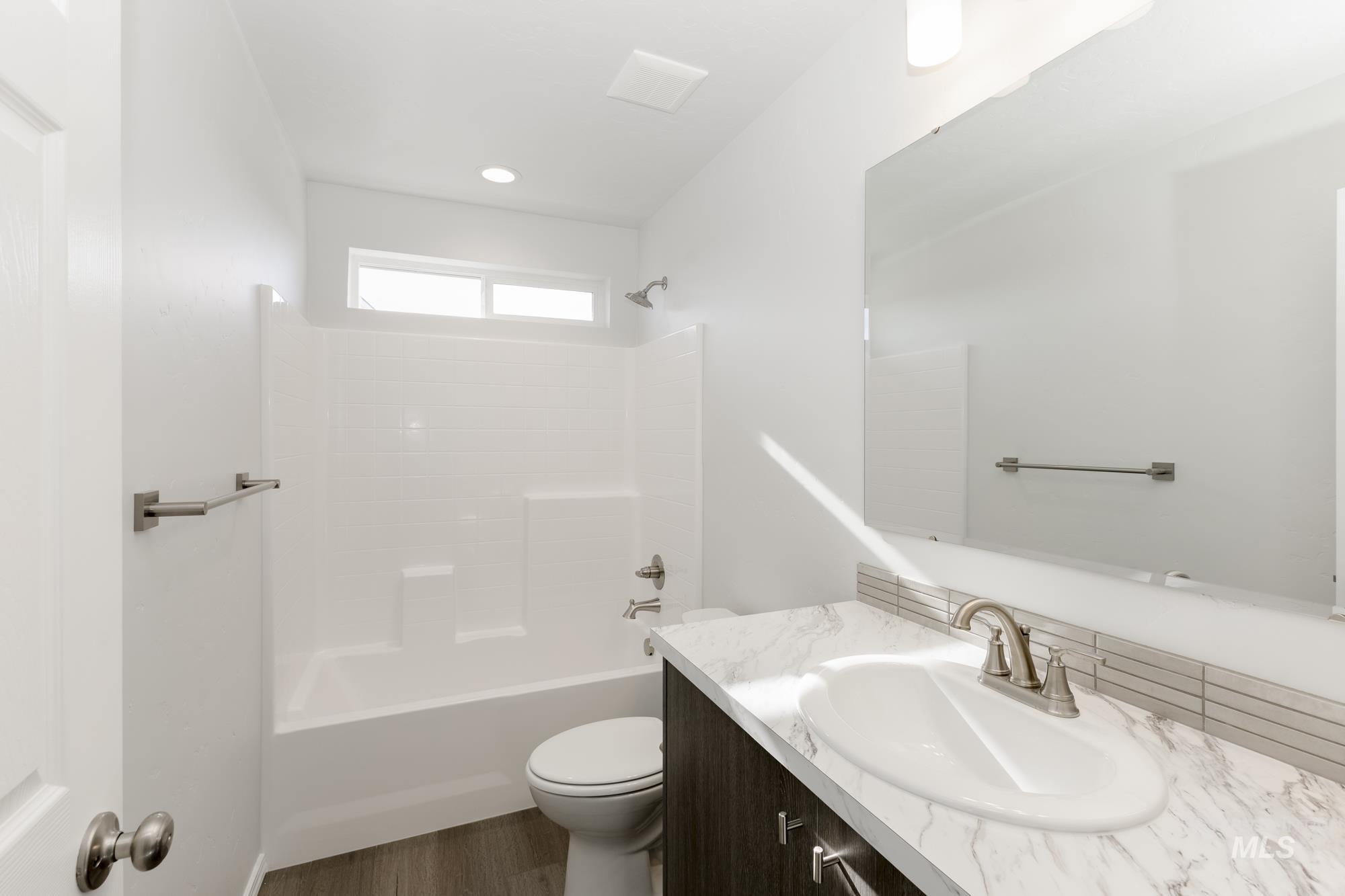 3070 South Maple Rnch Way Nampa, ID 83686 - Photo 24 of 33 Bathroom featuring shower / bathtub combination, vanity, and dark wood-style floors