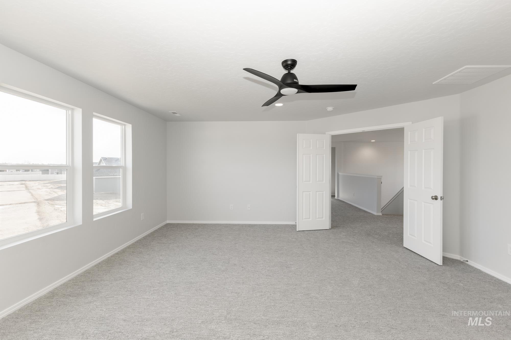 3070 South Maple Rnch Way Nampa, ID 83686 - Photo 28 of 33 Unfurnished bedroom featuring light colored carpet and a ceiling fan