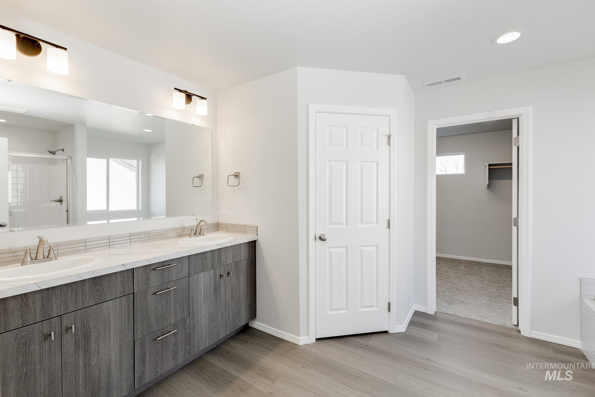 3070 South Maple Rnch Way Nampa, ID 83686 - Photo 29 of 33 Bathroom with a shower stall, double vanity, a spacious closet, healthy amount of natural light, and recessed lighting