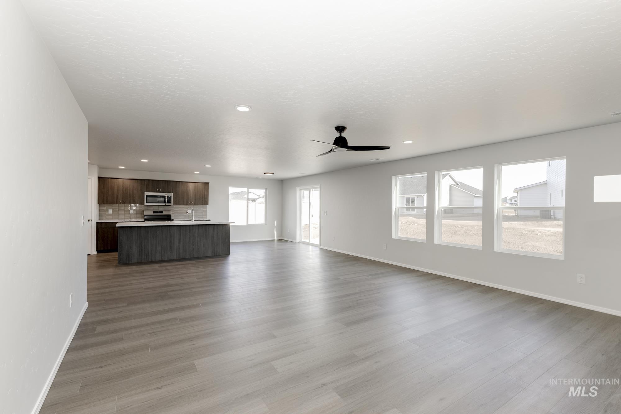 3070 South Maple Rnch Way Nampa, ID 83686 - Photo 10 of 33 Unfurnished living room featuring a ceiling fan, recessed lighting, and light wood-type flooring