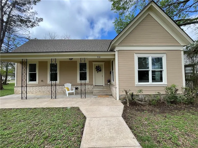 a front view of house with outdoor seating
