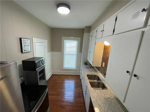 a view of kitchen island with furniture and entryway