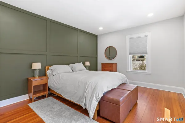 a bedroom with a bed and chair