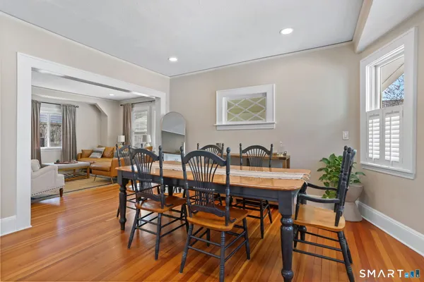 a view of a dining room with furniture window and wooden floor