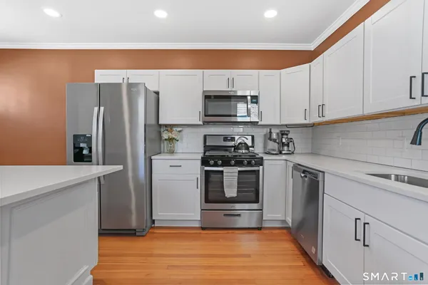 a kitchen with stainless steel appliances a refrigerator stove and sink