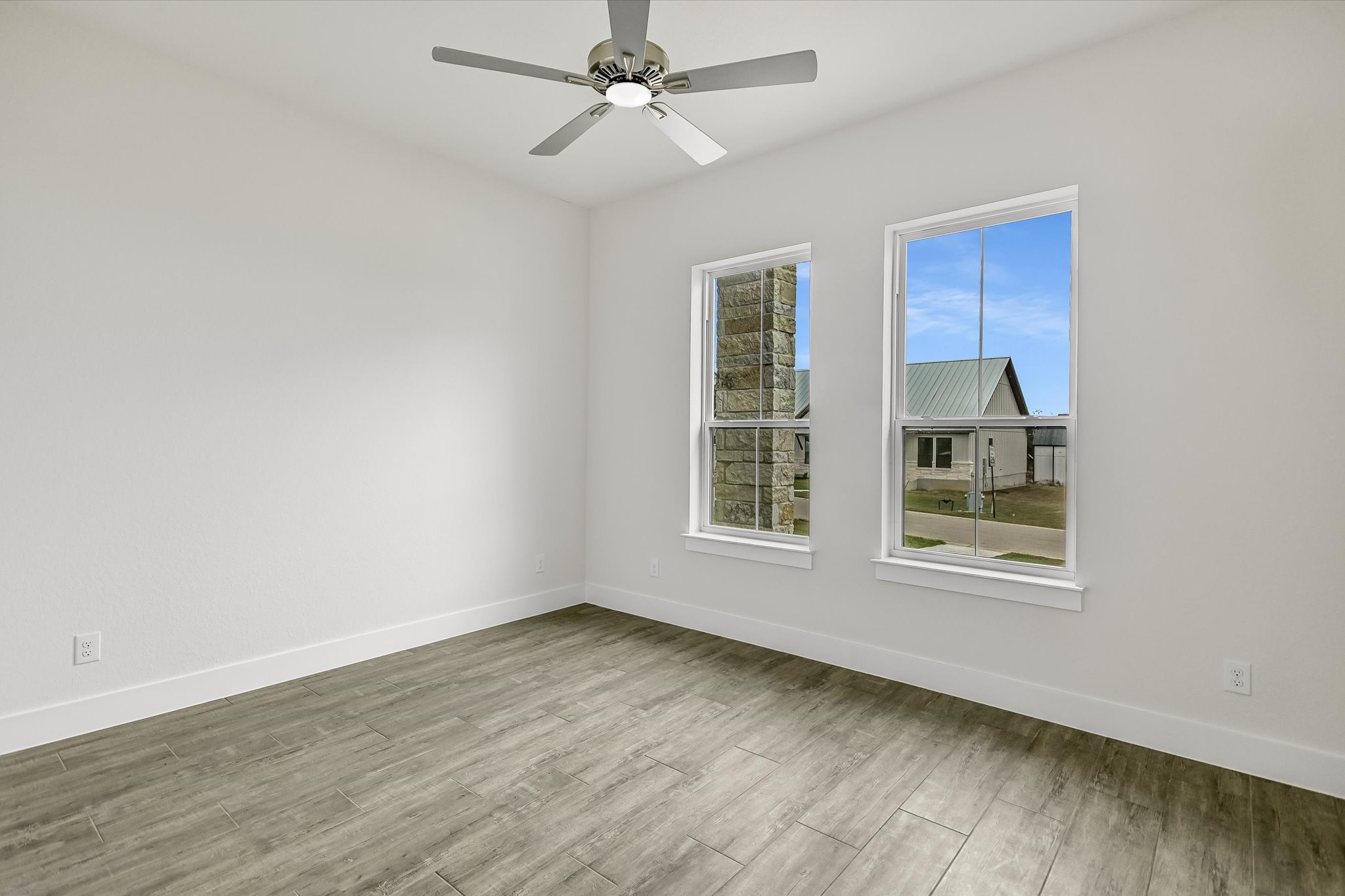 32 Peace Pipe Wimberley, TX 78676 - Photo 16 of 20 Unfurnished room with light wood-style floors and ceiling fan