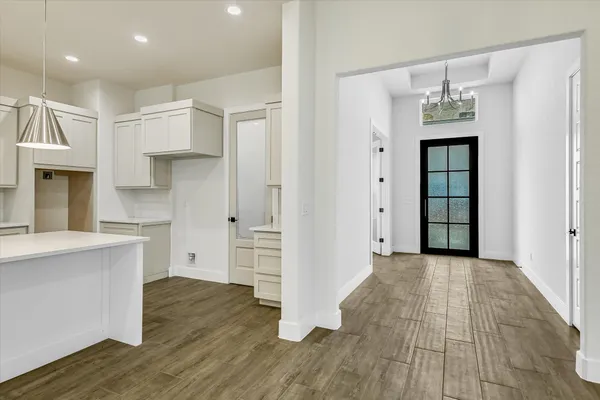a view of a kitchen cabinets wooden floor and a kitchen