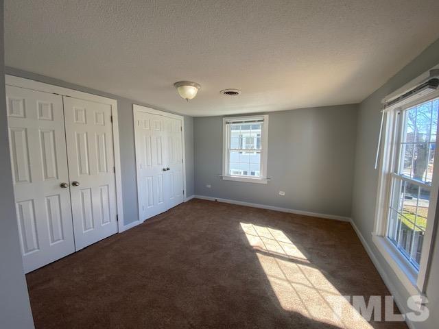107 North 12th Street Erwin, NC 28339 - Photo 11 of 23 an empty room with windows