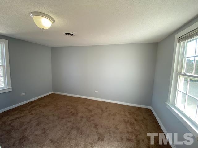 107 North 12th Street Erwin, NC 28339 - Photo 14 of 23 an empty room with windows