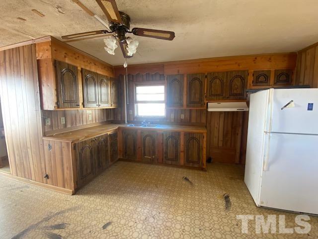 107 North 12th Street Erwin, NC 28339 - Photo 20 of 23 a kitchen with refrigerator and cabinets