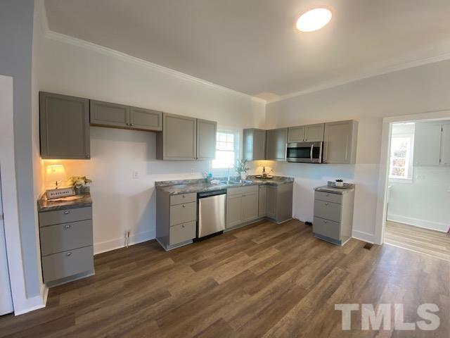 107 North 12th Street Erwin, NC 28339 - Photo 4 of 23 a kitchen with white cabinets and white appliances