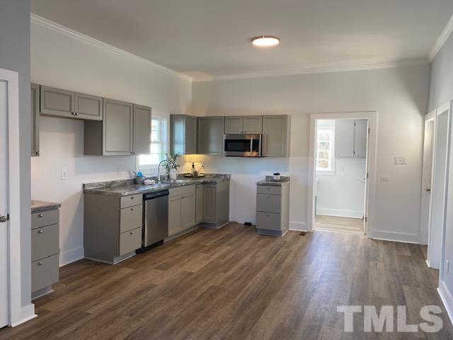 107 North 12th Street Erwin, NC 28339 - Photo 5 of 23 a kitchen with white cabinets and white appliances