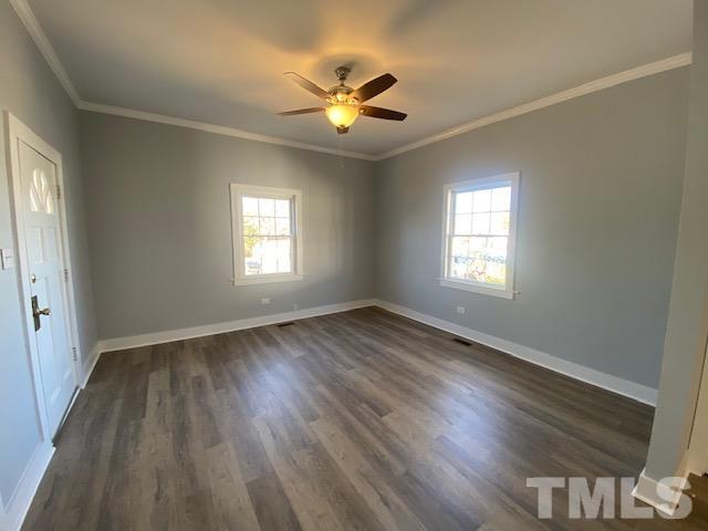 107 North 12th Street Erwin, NC 28339 - Photo 7 of 23 a view of empty room with wooden floor and fan