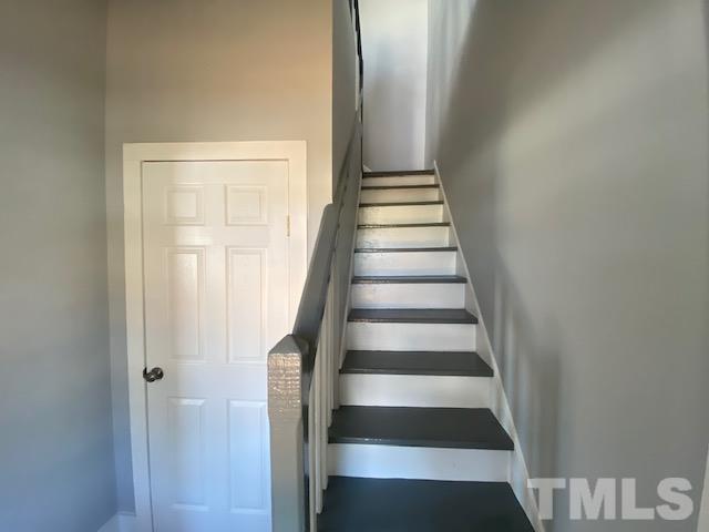 107 North 12th Street Erwin, NC 28339 - Photo 8 of 23 a view of staircase with white walls and a window