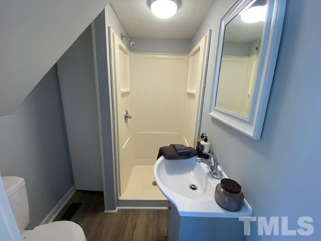 107 North 12th Street Erwin, NC 28339 - Photo 10 of 23 a bathroom with a sink mirror and toilet