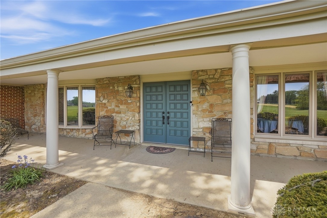 5669 O Neall Road Waynesville, OH 45068 - Photo 17 of 72 Elegant entrance featuring a welcoming porch with stone accents and inviting double doors.