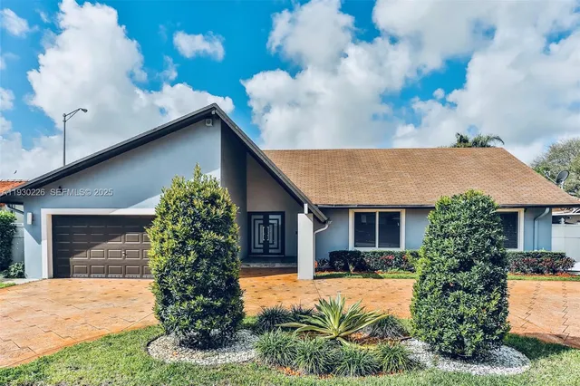 a front view of a house with garden